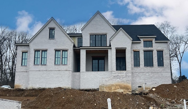 view of front of house with brick siding and crawl space