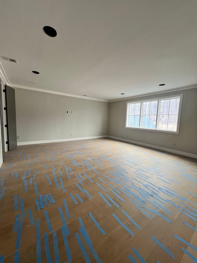 unfurnished room featuring visible vents, crown molding, and baseboards