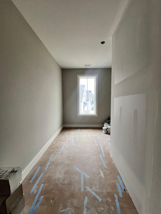 spare room featuring visible vents and baseboards