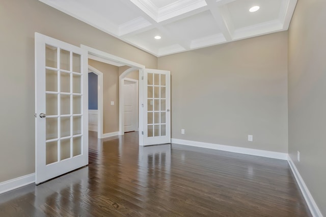 empty room with dark hardwood / wood-style flooring, beam ceiling, french doors, and coffered ceiling