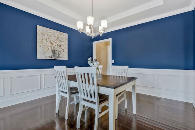 dining area with crown molding, dark hardwood / wood-style flooring, and a notable chandelier