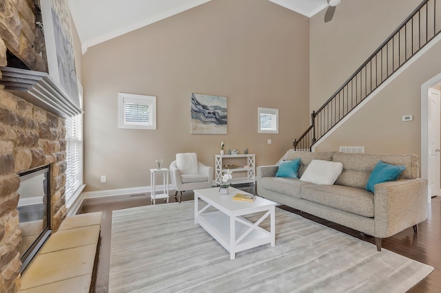 living room with high vaulted ceiling, a wealth of natural light, and wood-type flooring