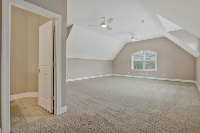 additional living space featuring ceiling fan, light carpet, and vaulted ceiling