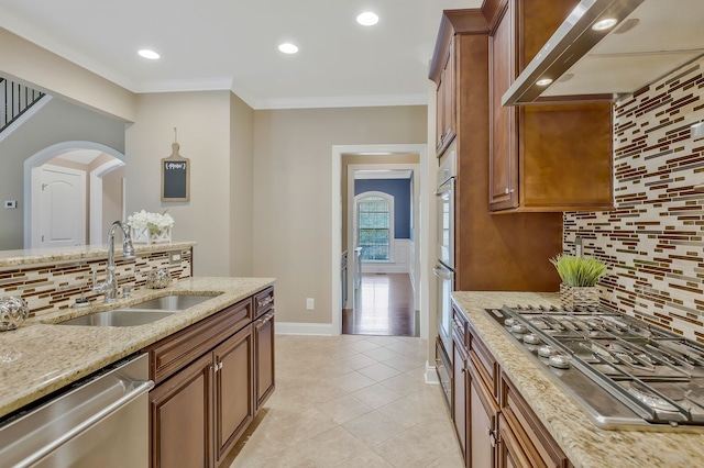 kitchen with stainless steel appliances, sink, ornamental molding, exhaust hood, and backsplash