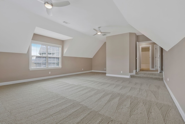 additional living space with ceiling fan, light carpet, and vaulted ceiling