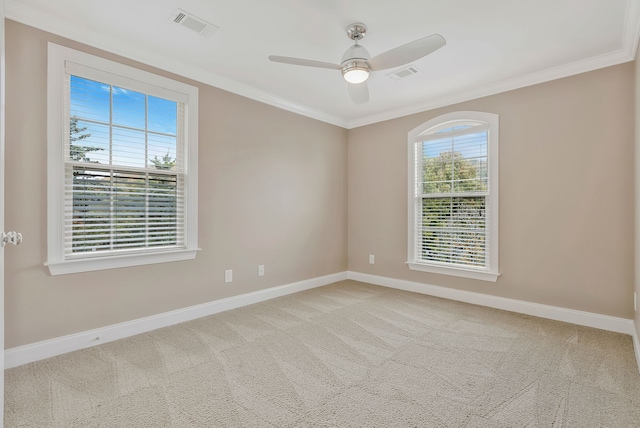 unfurnished room with light carpet, ceiling fan, and crown molding