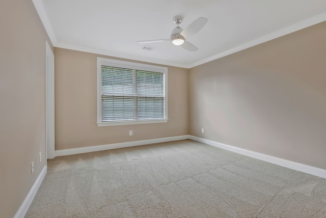 carpeted spare room with ornamental molding and ceiling fan