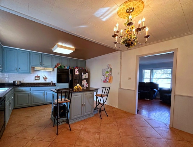 kitchen with backsplash, crown molding, black appliances, pendant lighting, and a notable chandelier