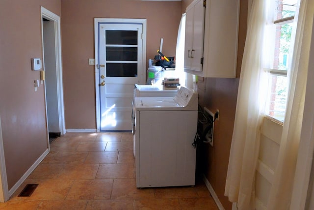 laundry room with cabinets, independent washer and dryer, and plenty of natural light