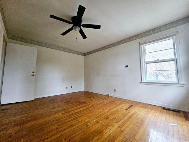 spare room featuring ceiling fan and hardwood / wood-style flooring