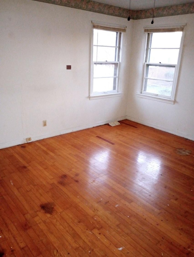 unfurnished room with wood-type flooring