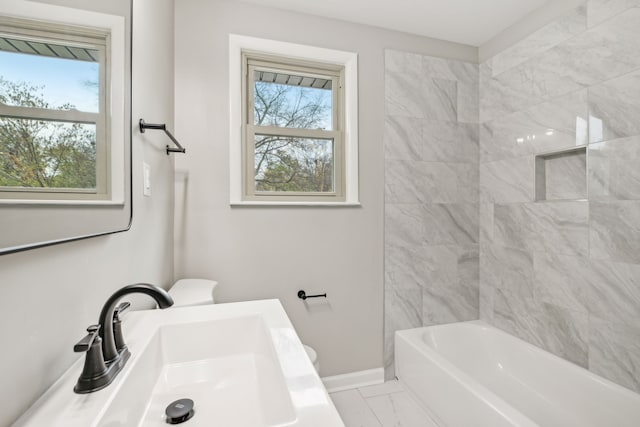 bathroom featuring sink and tiled shower / bath combo