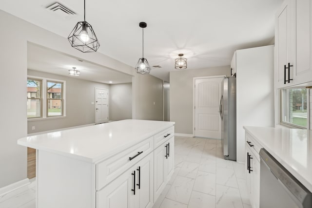 kitchen with white cabinets, pendant lighting, appliances with stainless steel finishes, and a center island