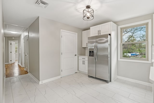 kitchen featuring white cabinetry, stainless steel refrigerator with ice dispenser, and light wood-type flooring