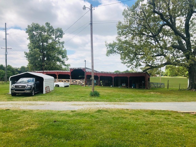 view of front facade with an outbuilding and a front yard