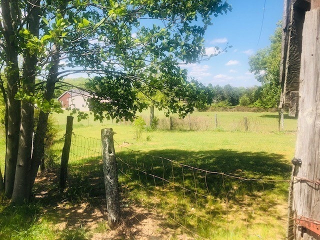 view of yard with a rural view