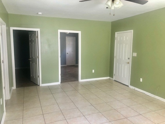 spare room featuring ceiling fan and light tile patterned floors