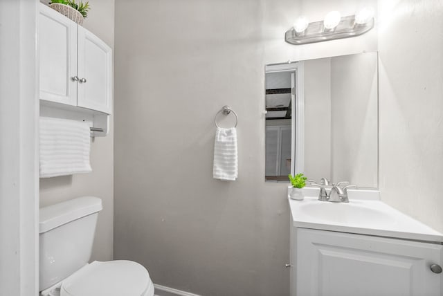 bathroom featuring toilet and vanity