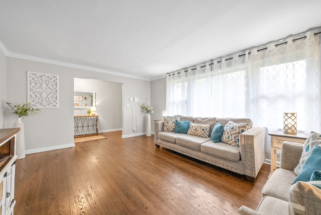 living room with dark wood-type flooring and crown molding