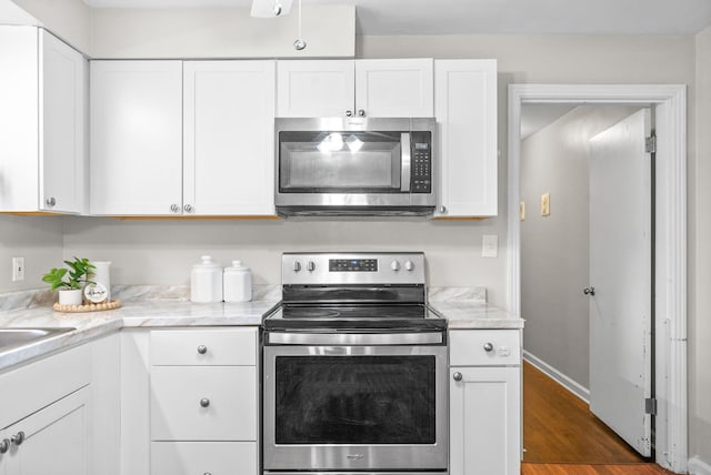 3 Hillwood Ct, Clarksville, TN 37043 - kitchen with appliances with stainless steel finishes, white cabinetry, and dark wood-style floors