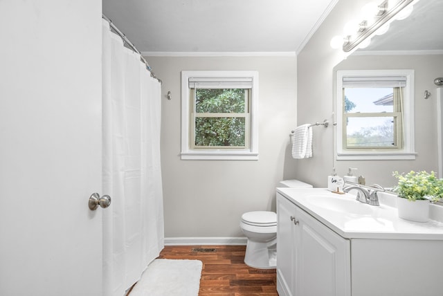 bathroom featuring toilet, vanity, wood-type flooring, and ornamental molding