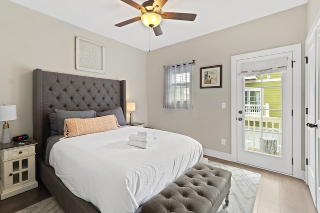 bedroom with access to outside, wood-type flooring, and ceiling fan