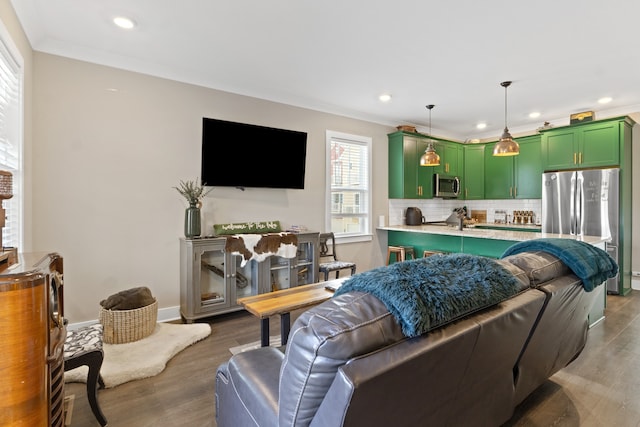 living room featuring wood-type flooring and ornamental molding