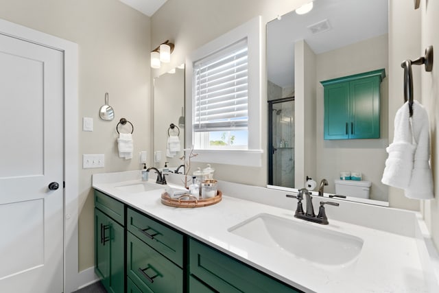 bathroom with a shower with door, vanity, and toilet