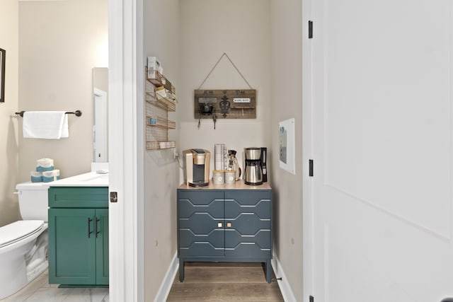 hallway with hardwood / wood-style floors