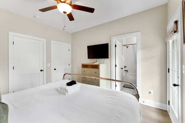 bedroom featuring ensuite bathroom, light hardwood / wood-style floors, and ceiling fan