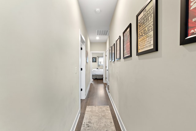 corridor with dark wood-type flooring