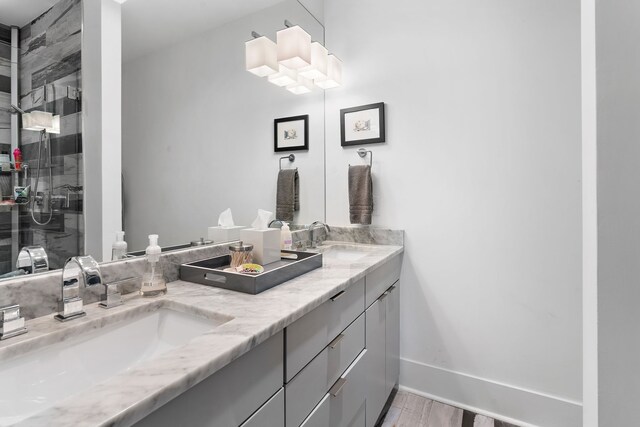 bathroom with hardwood / wood-style flooring, a shower with door, and vanity