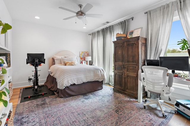 bedroom with hardwood / wood-style flooring and ceiling fan