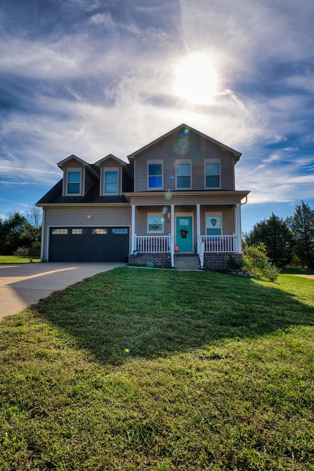 view of front of property with a garage, a porch, and a front yard