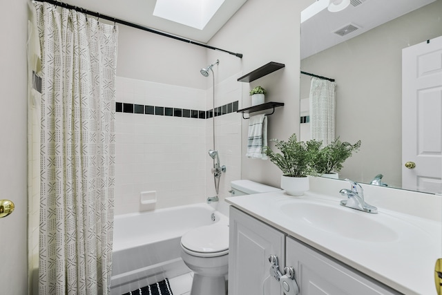 full bathroom with tile patterned floors, vanity, shower / bath combo with shower curtain, and toilet