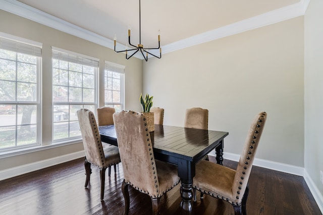 dining room with dark hardwood / wood-style flooring, an inviting chandelier, and crown molding