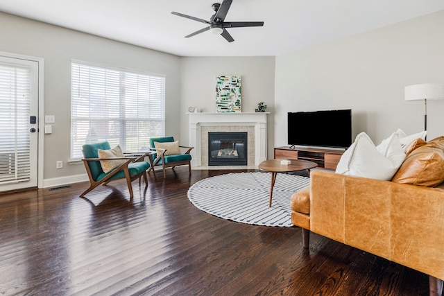 living room featuring hardwood / wood-style floors, a fireplace, and ceiling fan