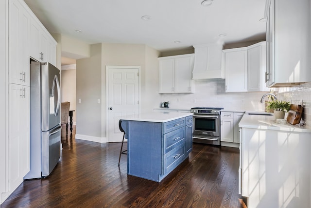 kitchen with white cabinetry, a center island, dark hardwood / wood-style floors, and stainless steel appliances