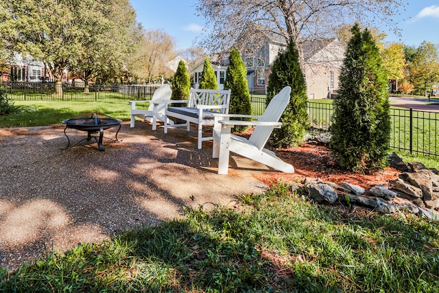 view of play area with a patio, a lawn, and an outdoor fire pit