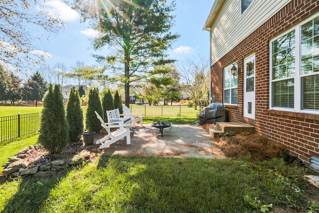 view of yard with a patio and a fire pit