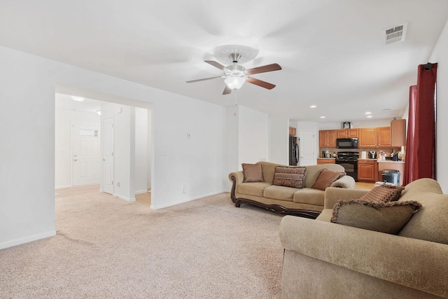 carpeted living room with ceiling fan