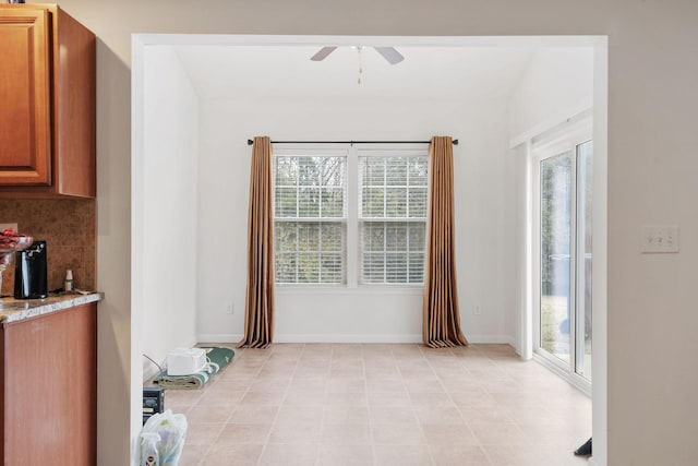 dining room featuring ceiling fan and a healthy amount of sunlight