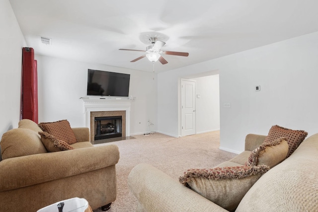 carpeted living room with ceiling fan