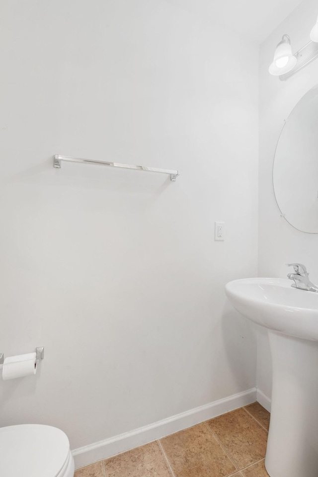 bathroom featuring tile patterned floors, toilet, and sink