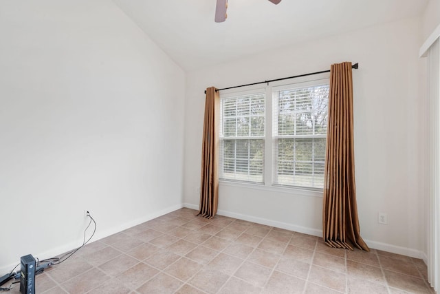 spare room with ceiling fan and vaulted ceiling