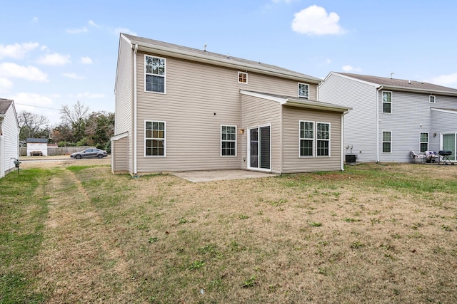 rear view of property featuring a lawn, a patio area, and cooling unit