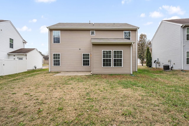 back of house featuring a lawn, central air condition unit, and a patio