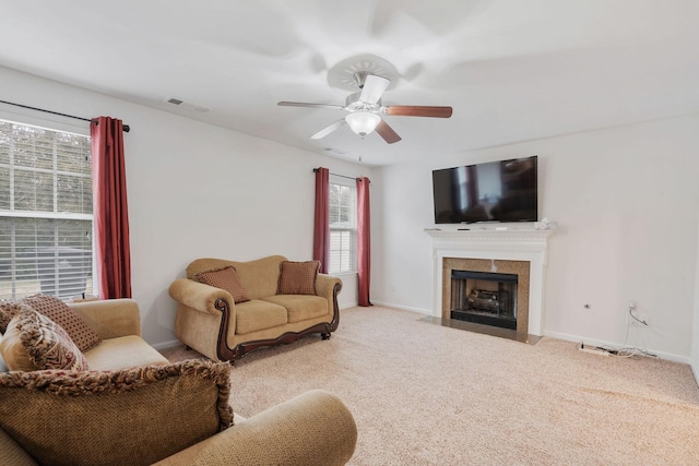 carpeted living room featuring ceiling fan