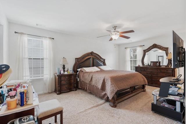 bedroom with light colored carpet and ceiling fan