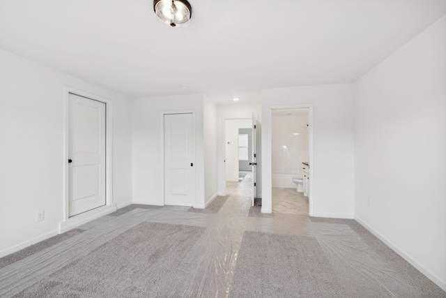 unfurnished room featuring light carpet